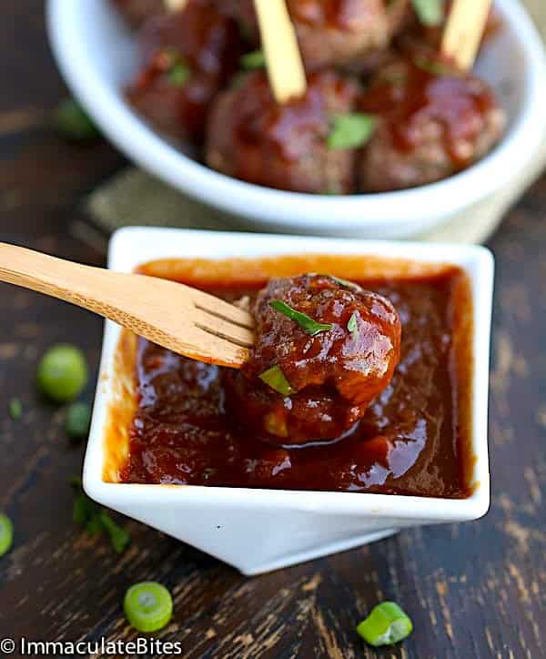Dipping a freshly baked meatball into insanely tasty pineapple BBQ sauce