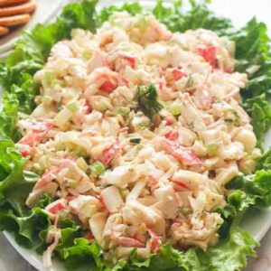 A plate lined with lettuce and loaded with delicious imitation crab salad