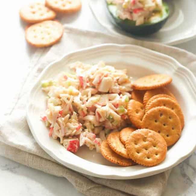 Enjoying imitation crab salad with crackers for an easy appetizer