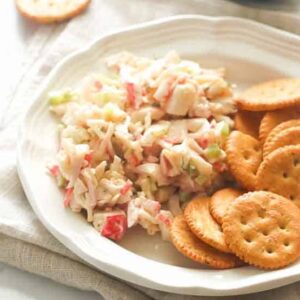 Enjoying imitation crab salad with crackers for an easy appetizer