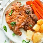 Freshly baked pork chops with carrots and potatoes ready to enjoy