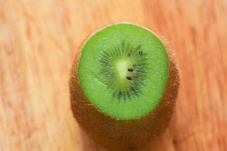 The first step in cutting a kiwi