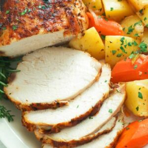 Sliced instant pot turkey breast with roasted carrots and potatoes