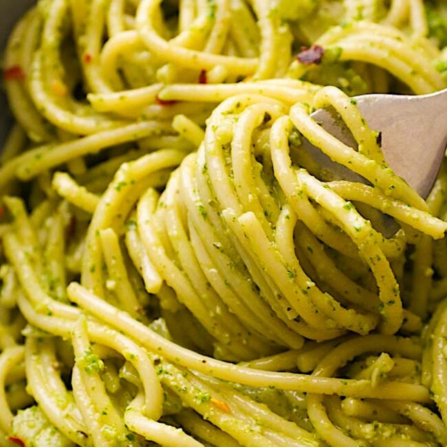 Spinning pasta on a fork, getting ready to take a tasty bite of pesto pasta