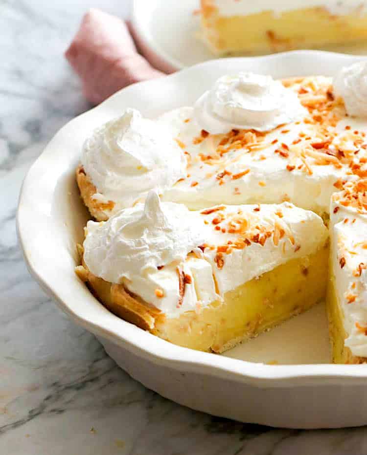 Slicing up ridiculously delicious coconut cream pie topped with whipped cream