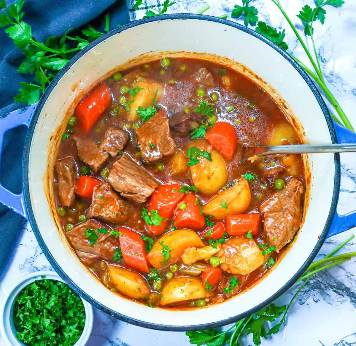 Soul-satisfying comfort food in the form of Dutch oven beef stew with parsley on the side