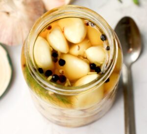 A full jar of pickled garlic ready to be enjoyed