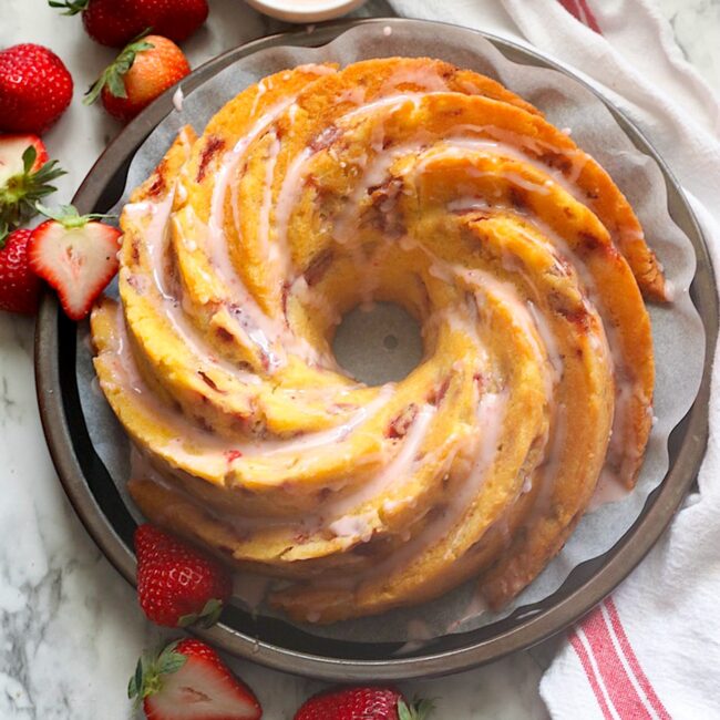 Glazing the finished strawberry bundt cake