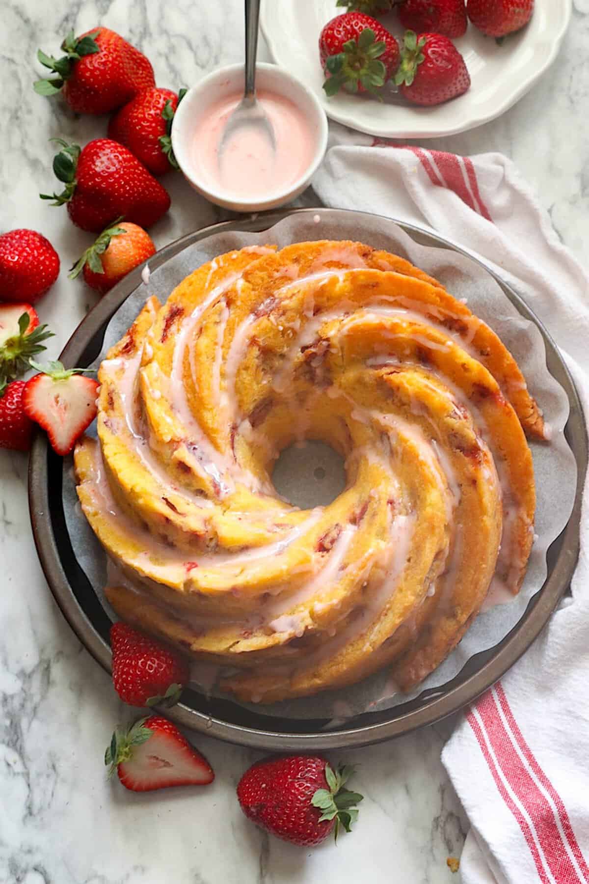 Glazing the finished strawberry bundt cake