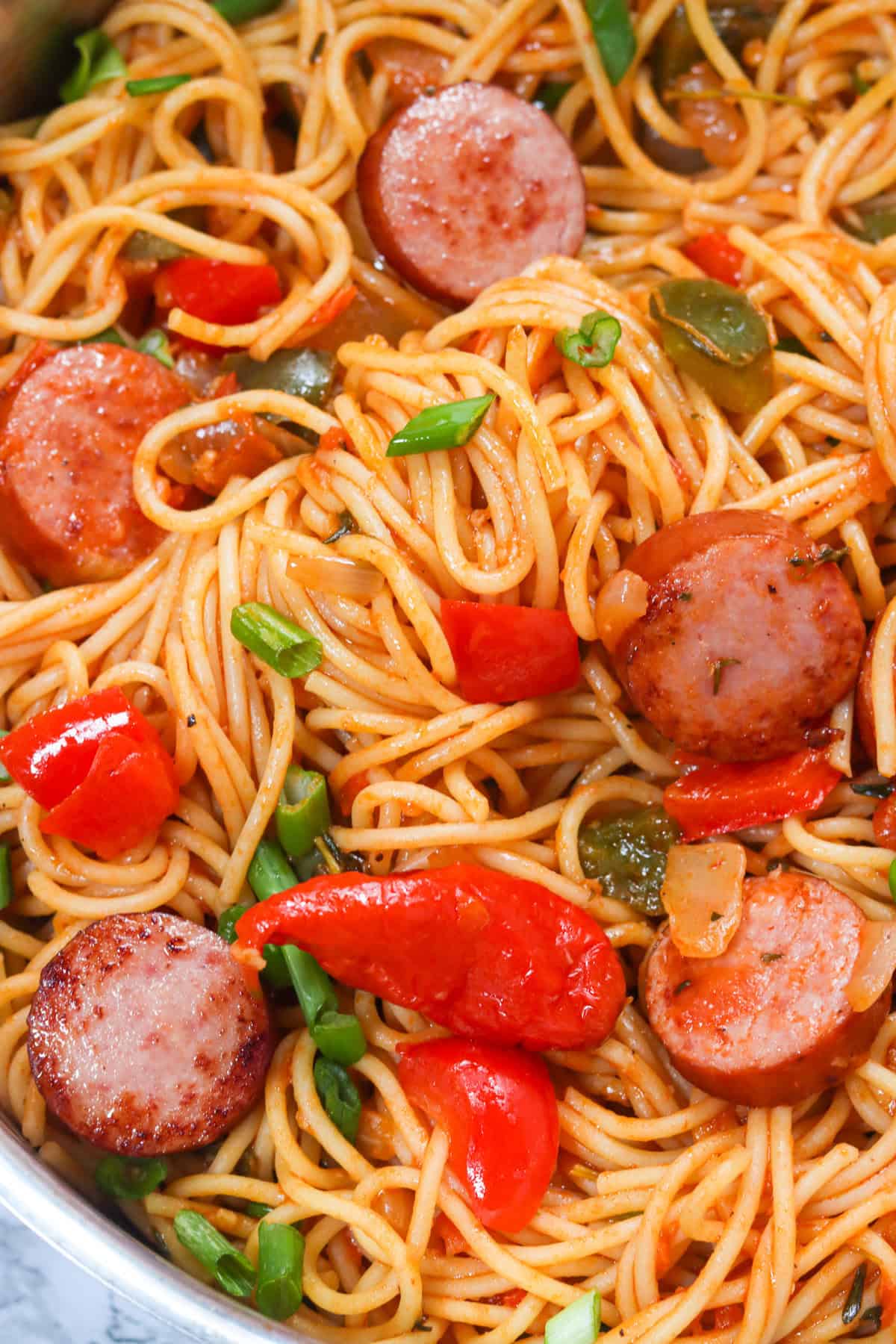 Getting a closeup of the spaghetti, sausage, and decadent sauce for Haitian spaghetti