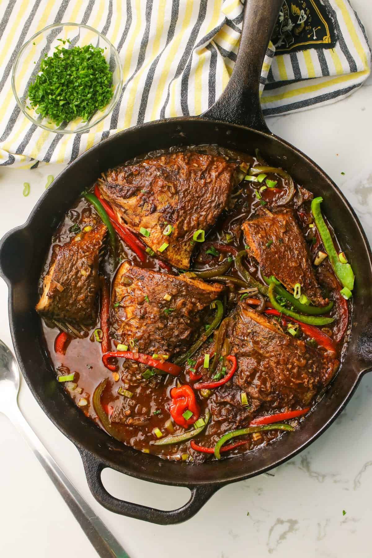 Brown stewed fish hot out of the skillet