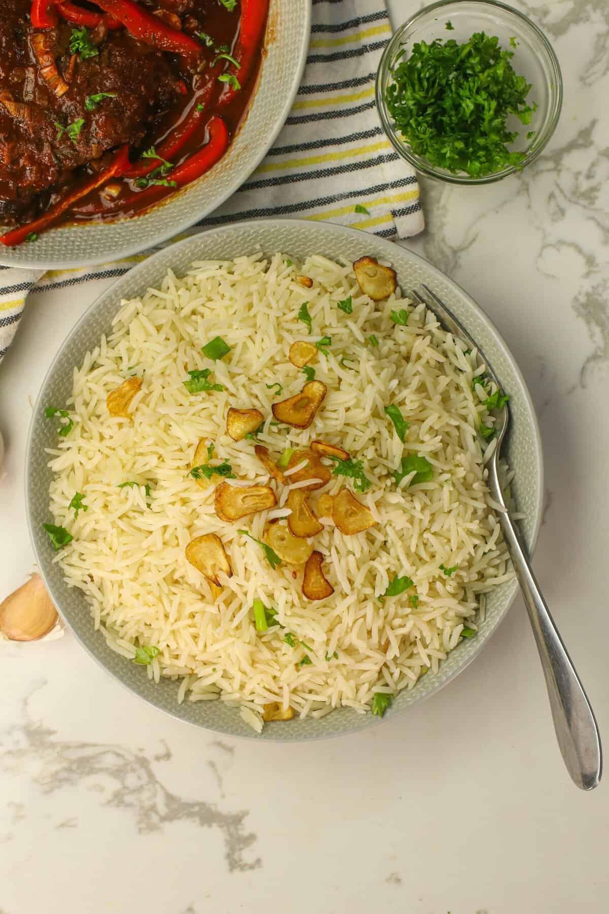 Serving up a bowl of garlic rice with an African stew