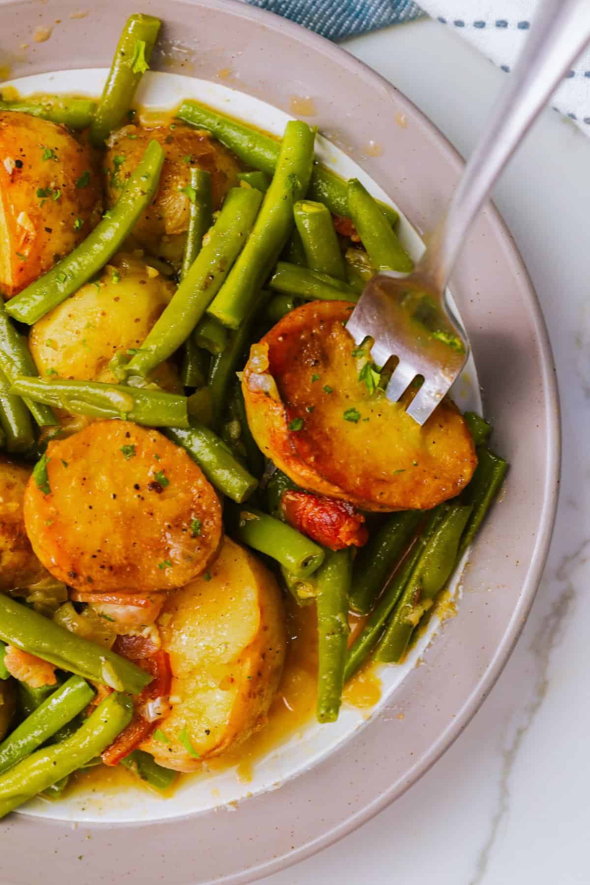 Diving a fork into nutritious and comforting green beans and potatoes