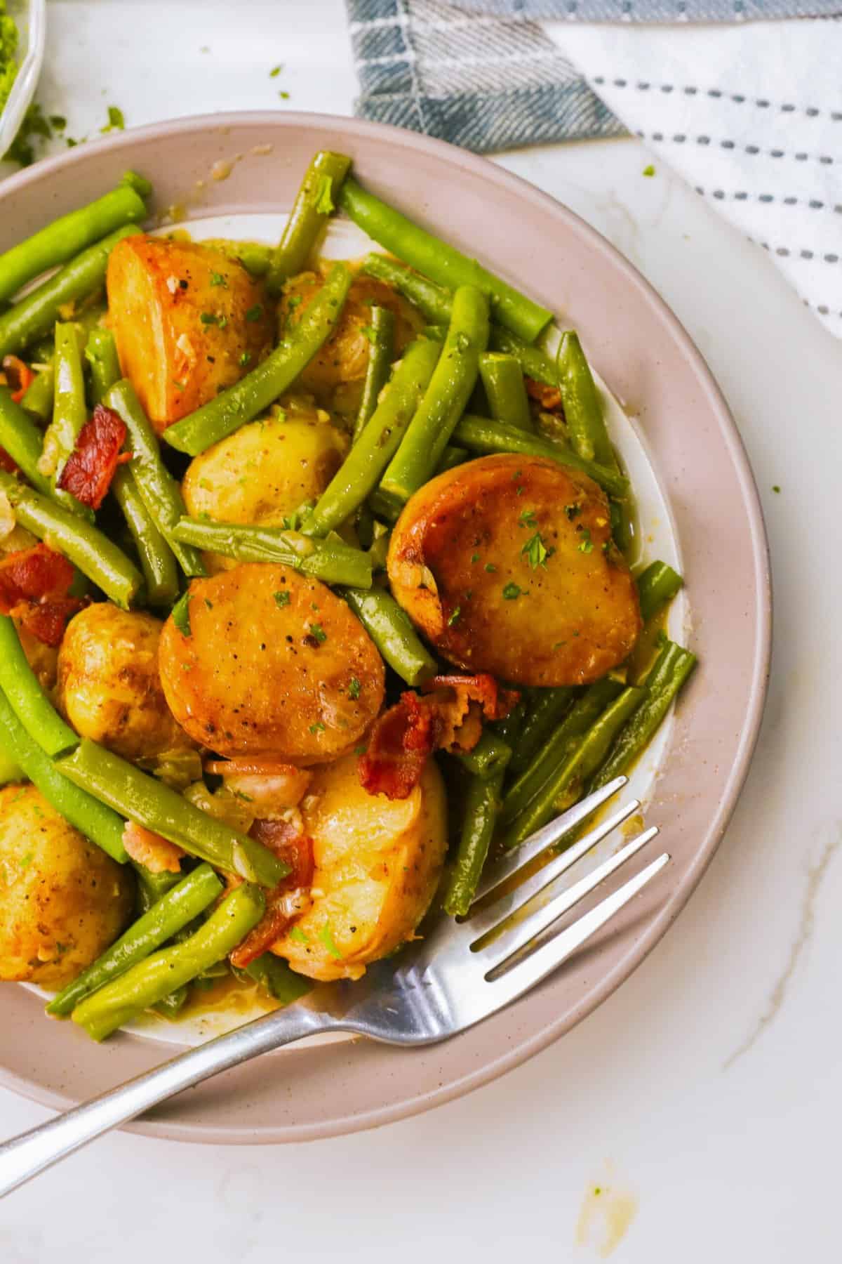 A serving of freshly cooked green beans and potatoes