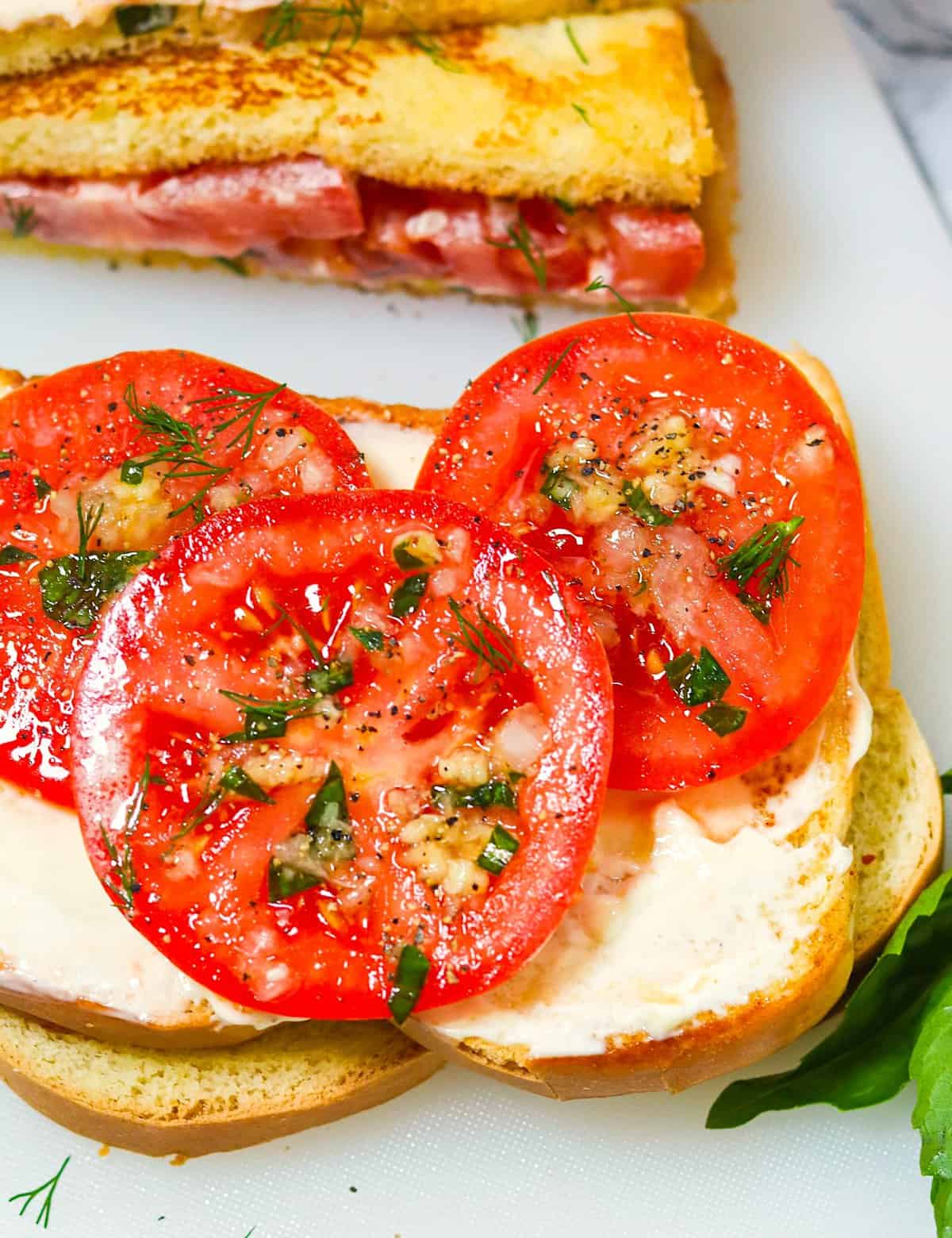 Assembling an insanely delicious Southern tomato sandwich