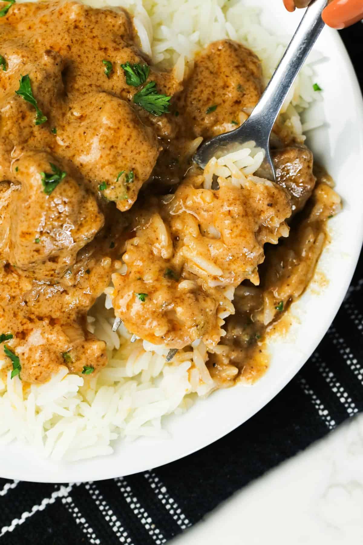 Enjoying homemade groundnut soup with white rice for an easy weeknight meal