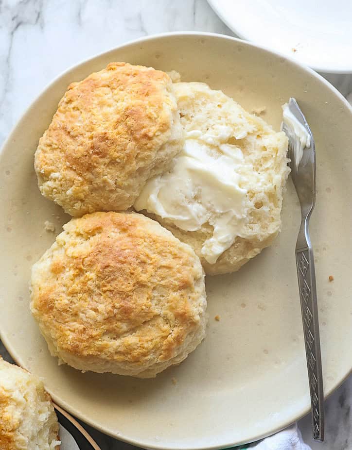 Spreading butter on a comfort food 7UP biscuit