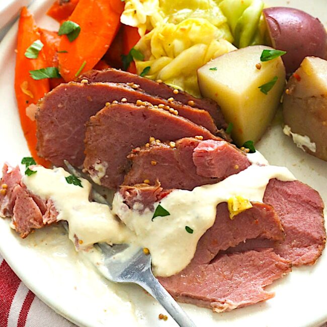 Drizzling slow cooker corned beef and cabbage drizzled with a delectable sauce