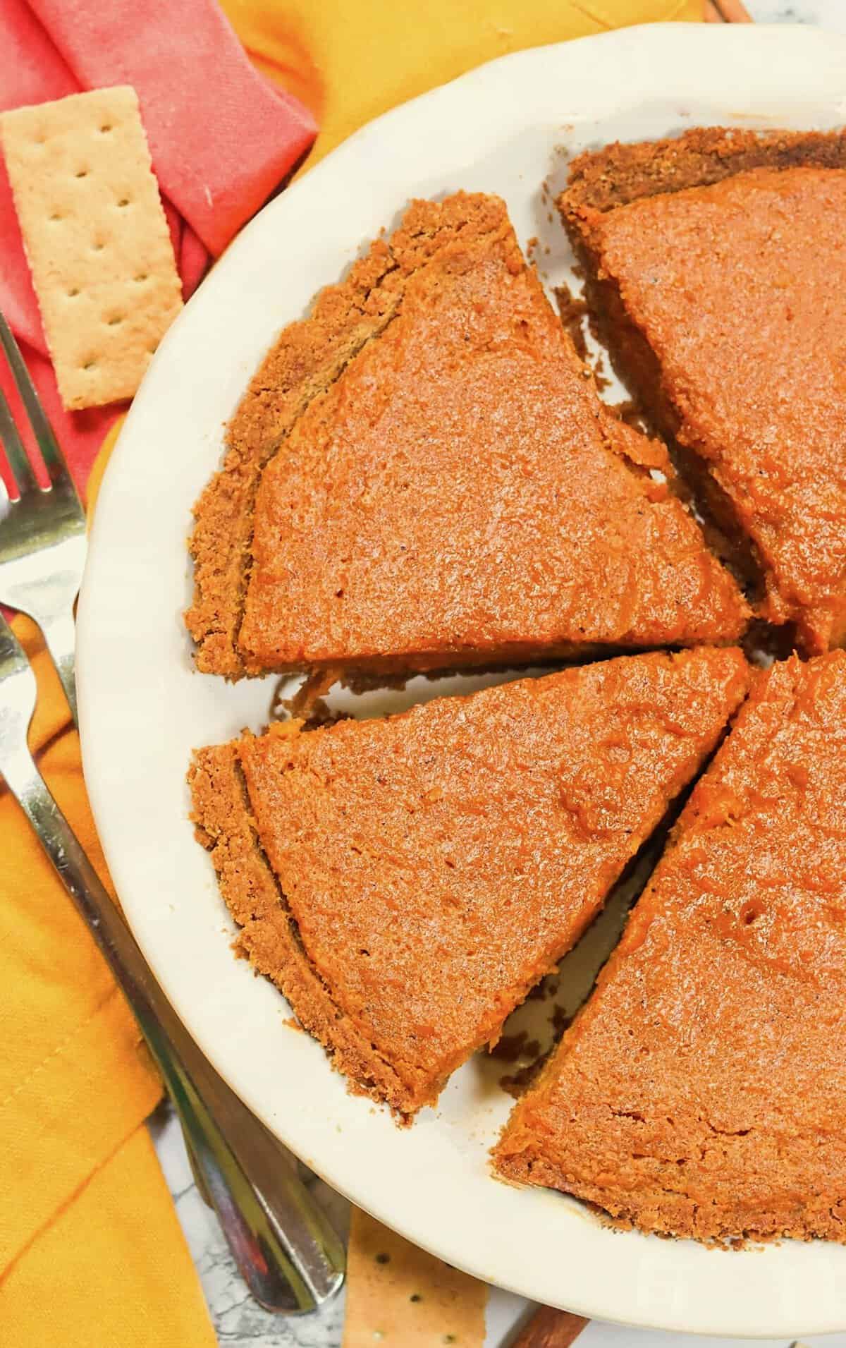 Slicing a freshly chilled sweet potato pie made even better with a graham cracker crust