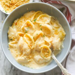 Diving into a bowl of delicious white cheddar mac and cheese