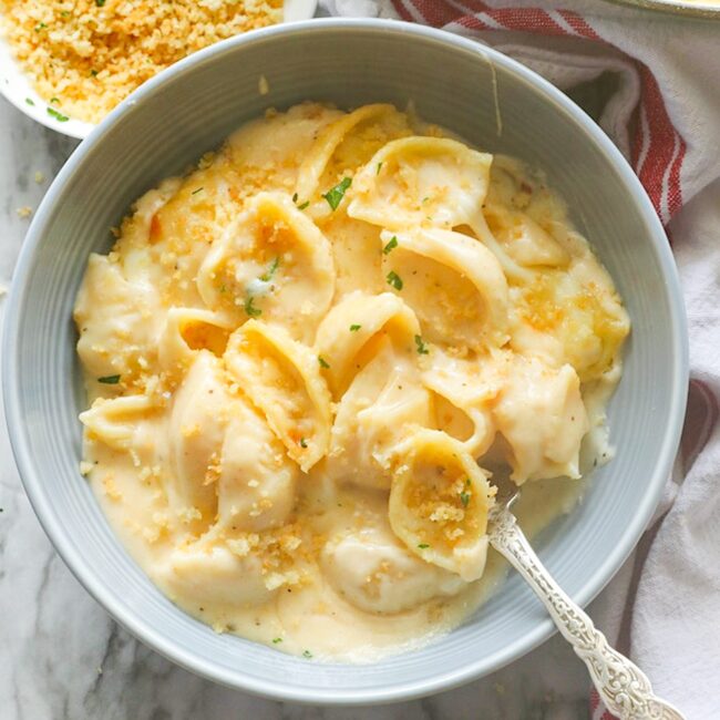 Diving into a bowl of delicious white cheddar mac and cheese