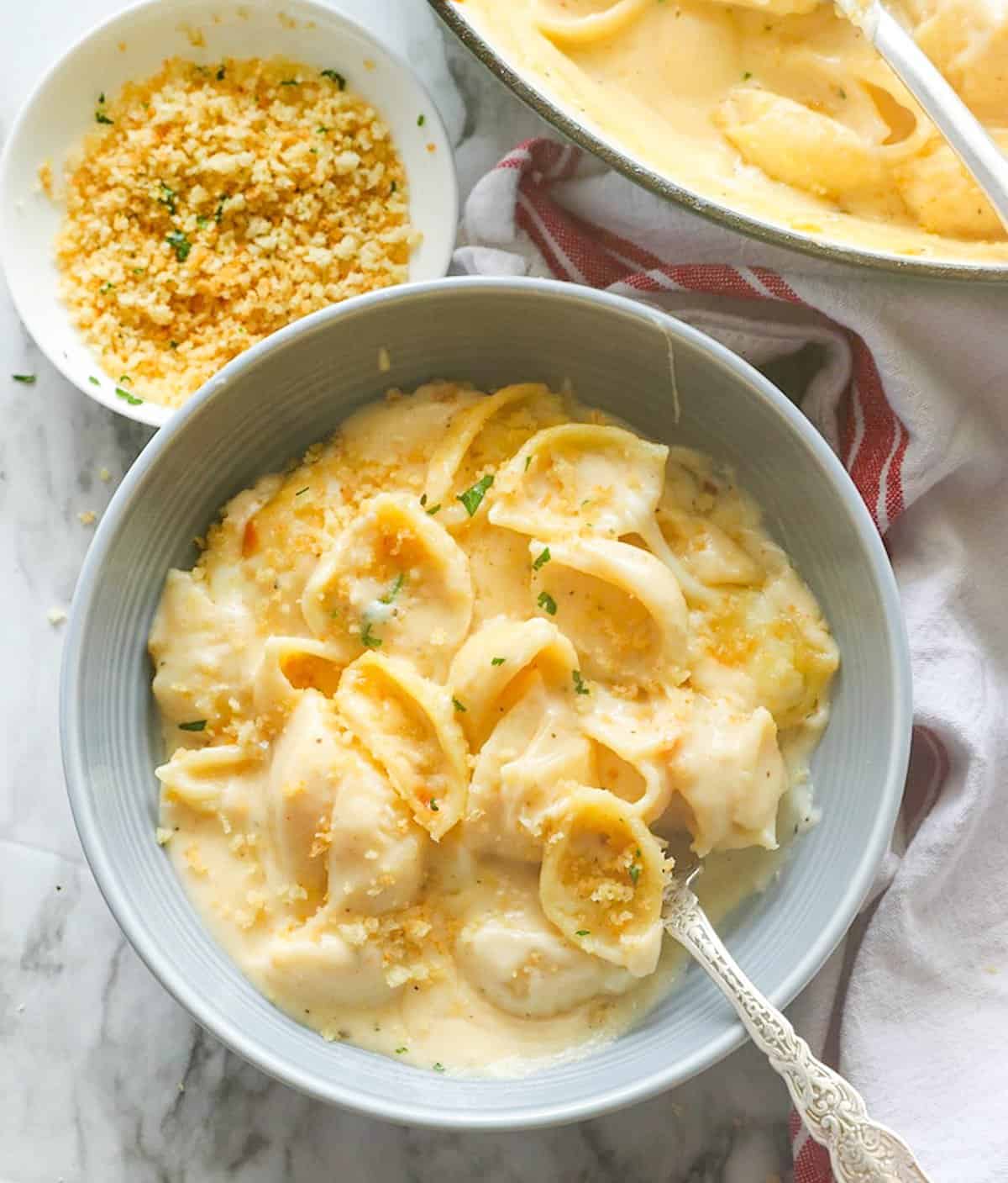 Diving into a bowl of delicious white cheddar mac and cheese