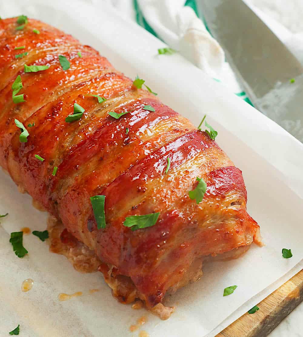 Fresh bacon-wrapped meatloaf fresh from the oven waiting to be sliced