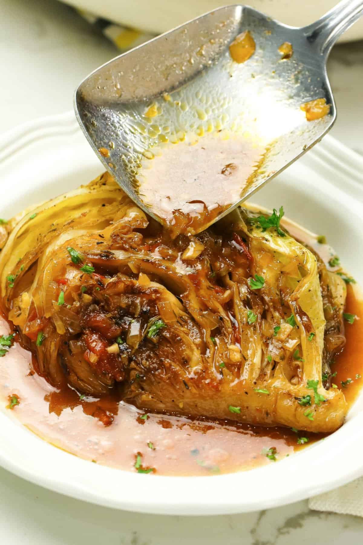 Drizzling a cabbage wedge with flavorful braising liquid