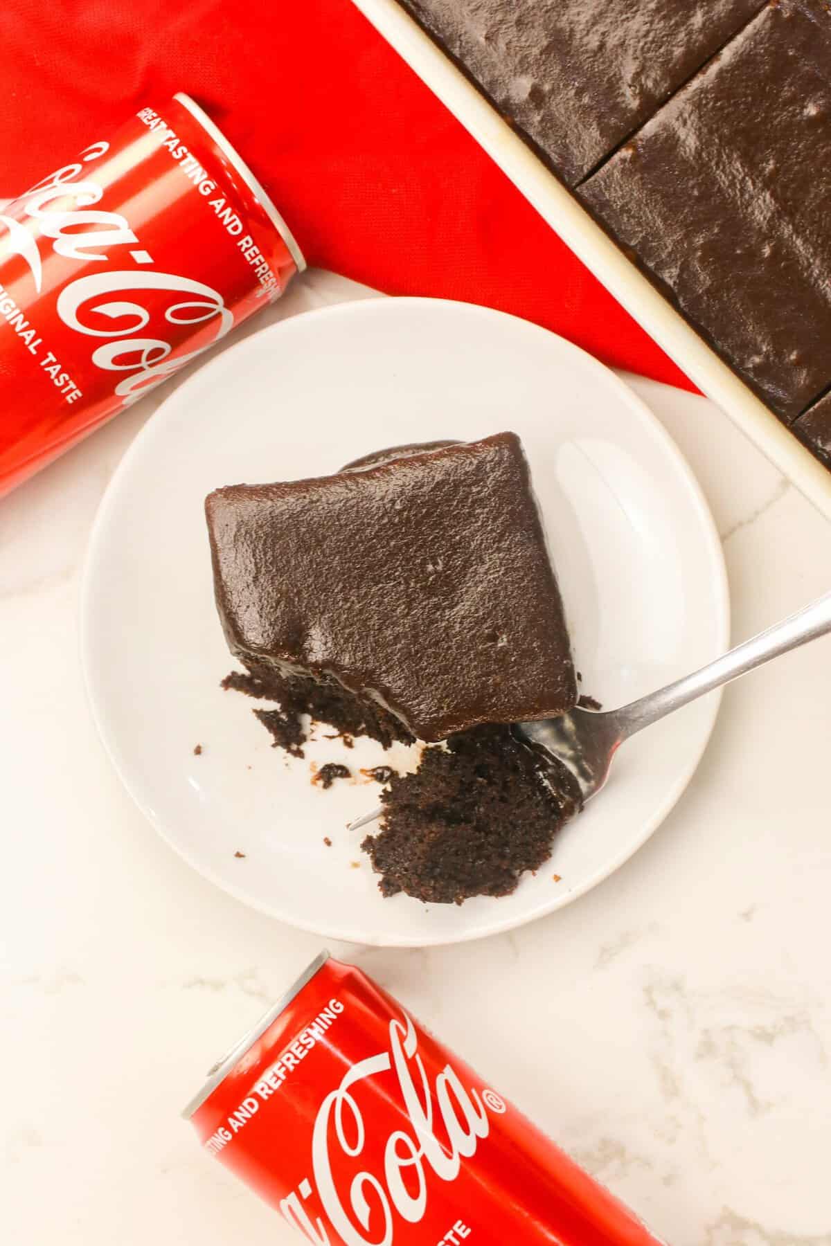 Enjoying a forkful of Coca-Cola Cake for pure chocolate indulgence