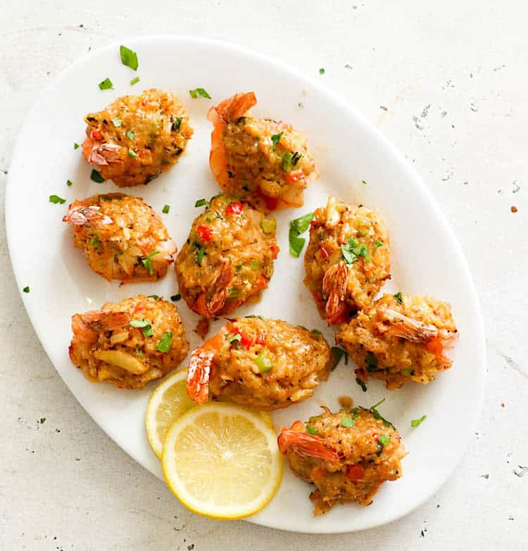 Delicious crab-stuffed shrimp served on a white platter, ready to serve