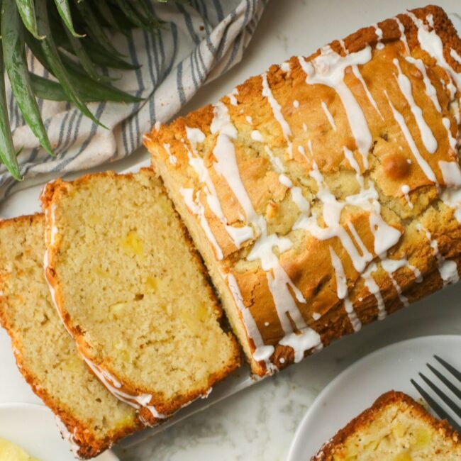 Slicing freshly glazed pineapple bread for a delectable afternoon snack