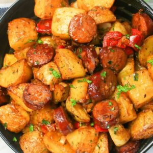 Serving up a black plate loaded with sausage and potatoes for comfort food deliciousness