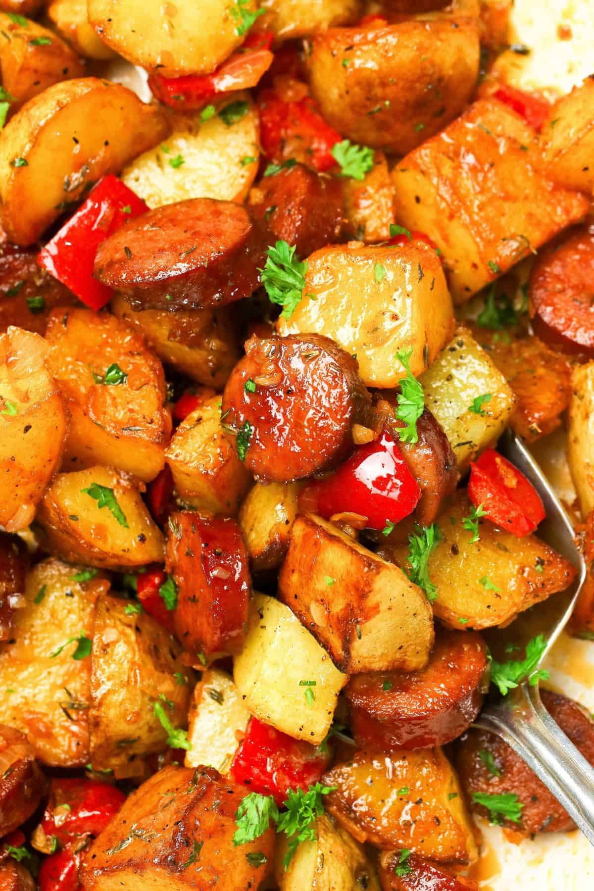 Taking a close up of crispy potatoes and smokey sausage for a quick and easy weeknight dinner