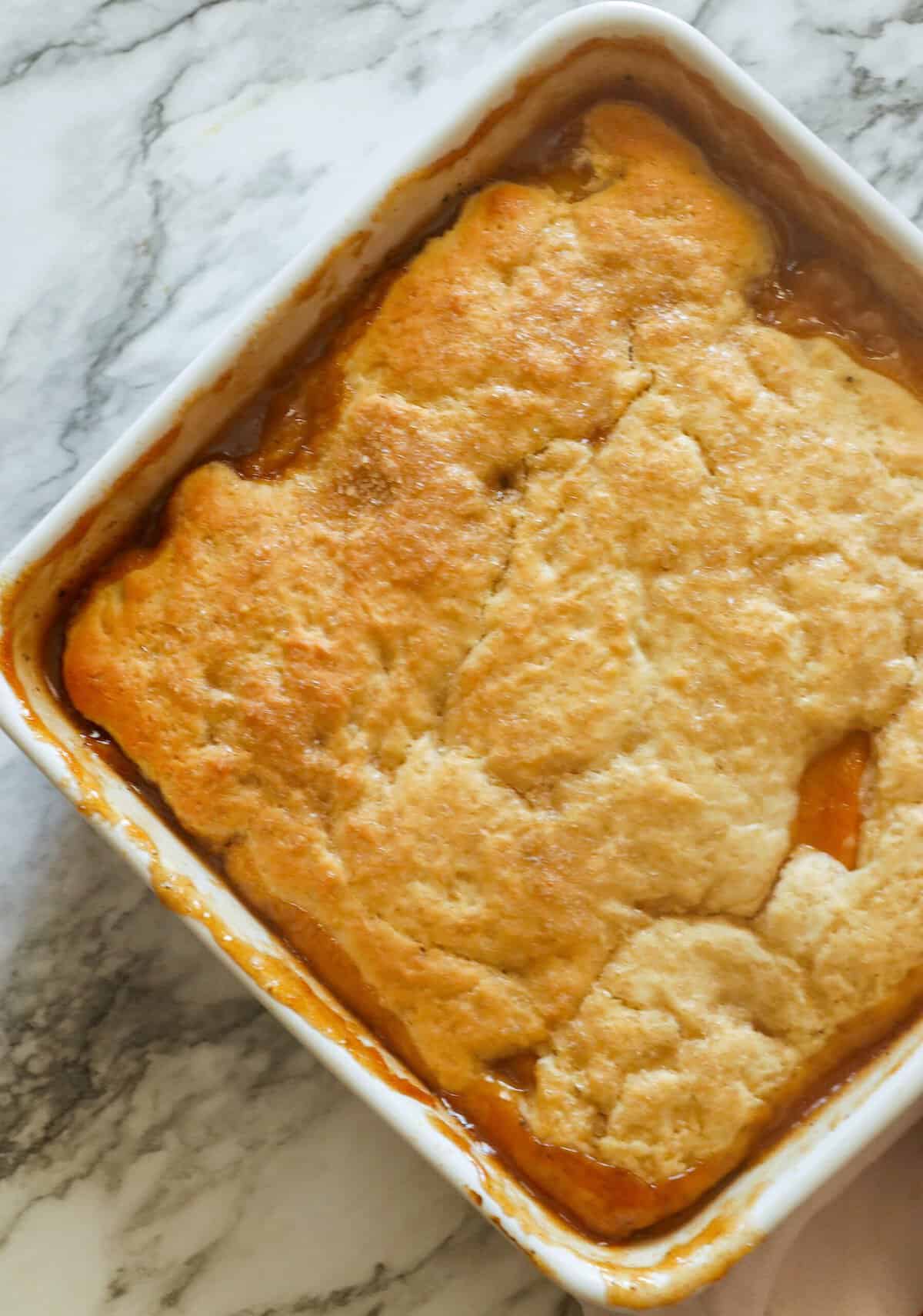 Freshly baked peach cobbler waiting to be served