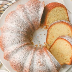 Fresh pound cake dusted with powdered sugar, sliced, and ready to enjoy