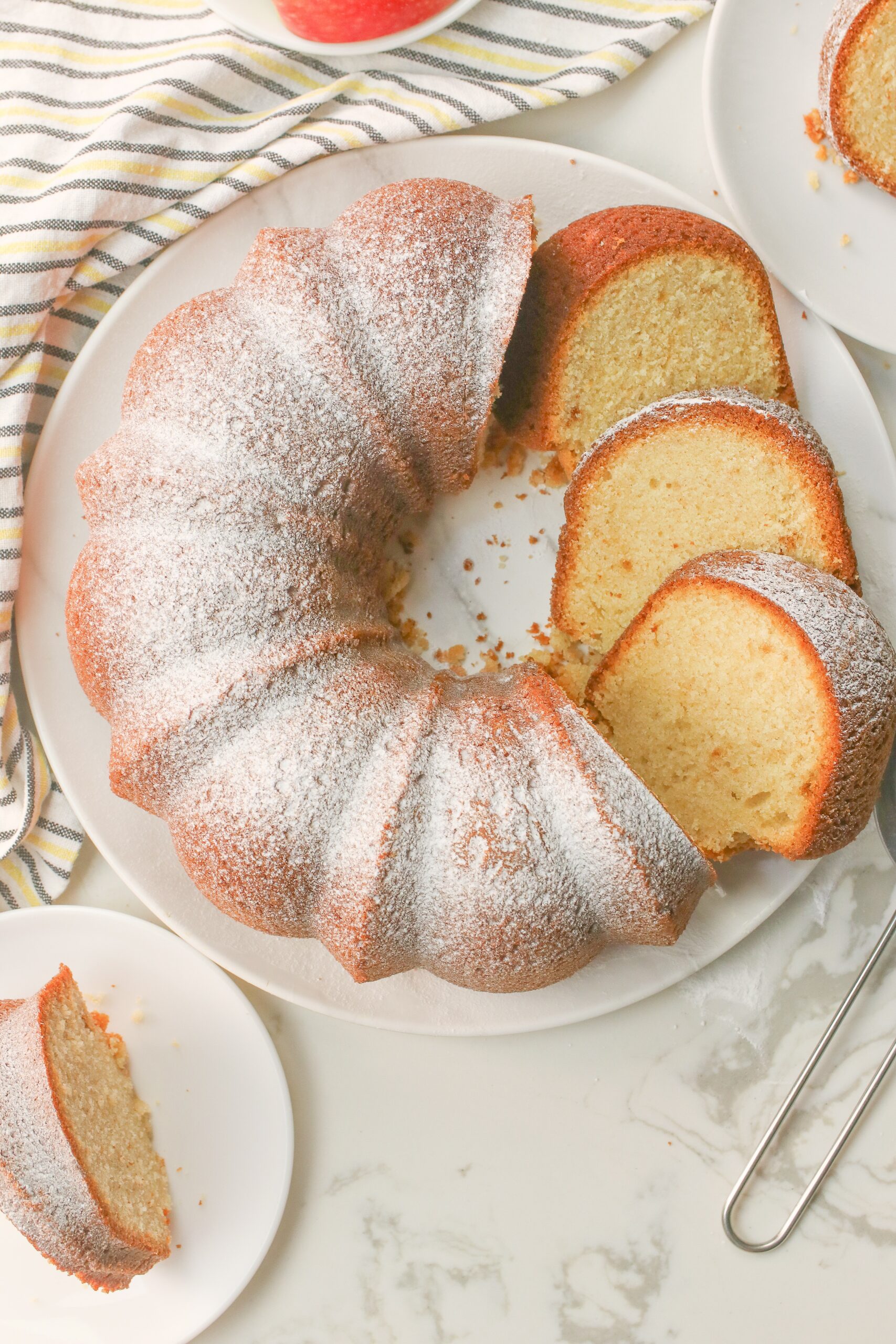 Fresh pound cake dusted with powdered sugar, sliced, and ready to enjoy