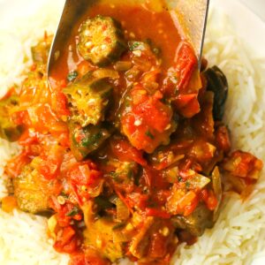 Piling super easy okra and tomatoes over rice