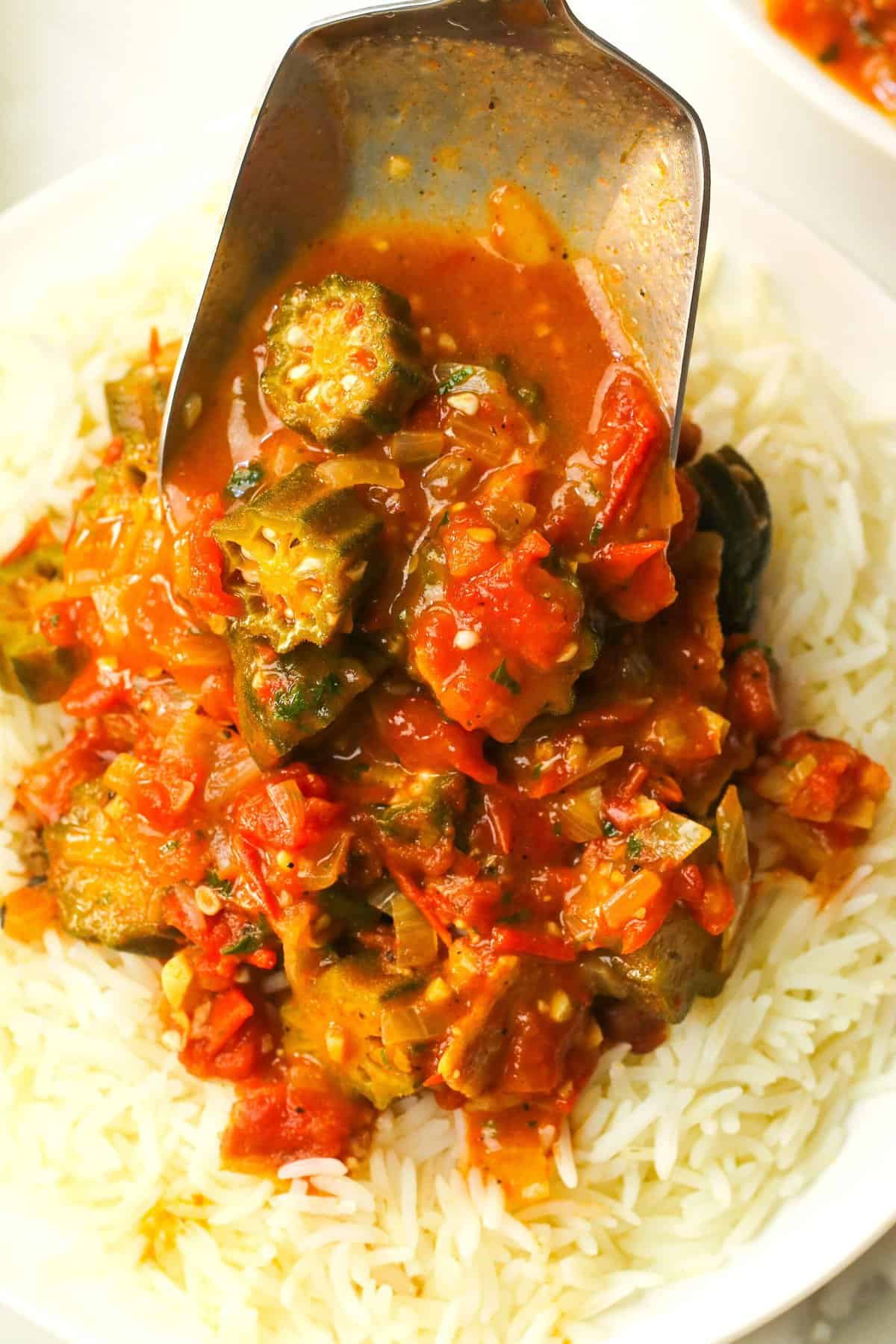 Piling super easy okra and tomatoes over rice