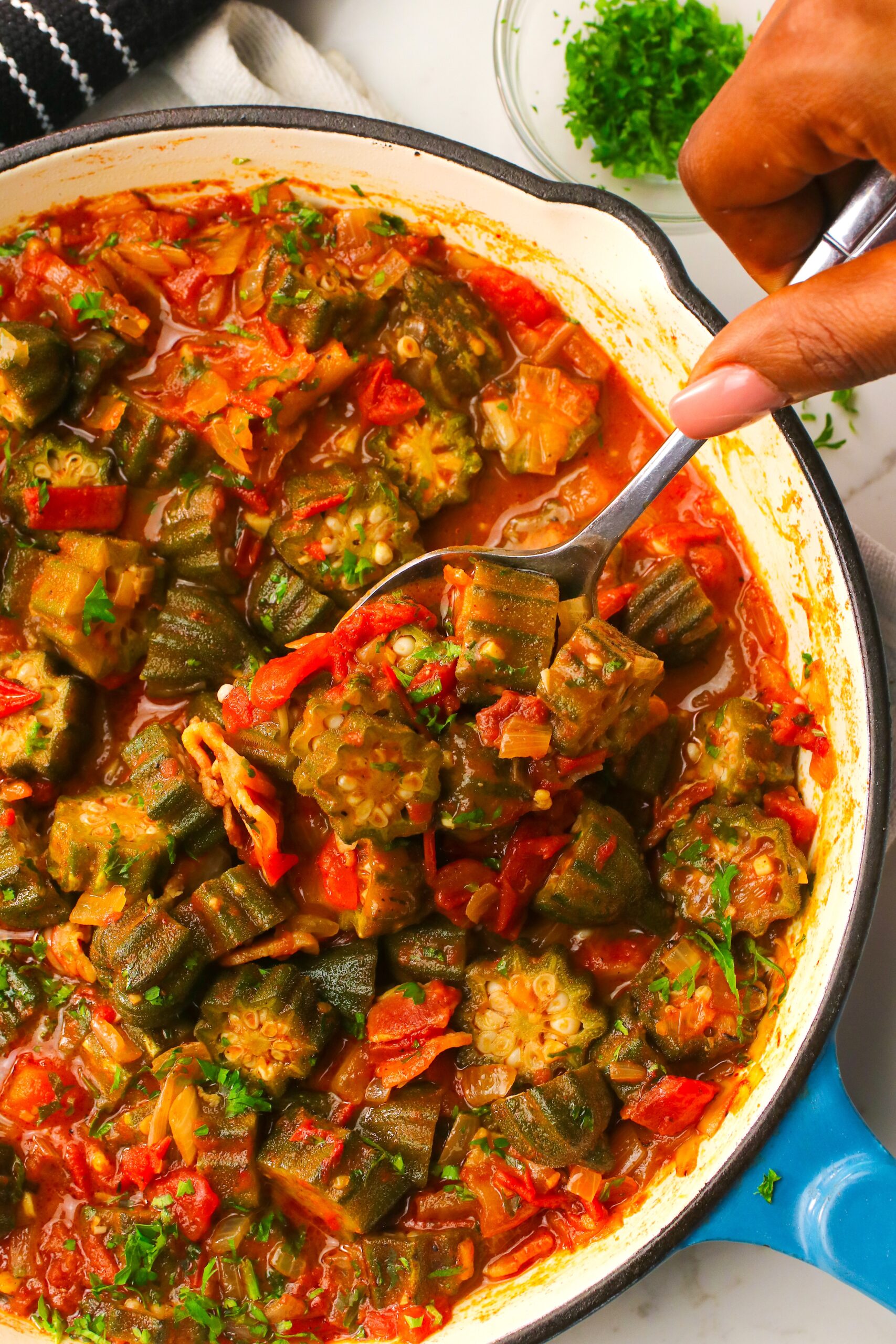 Serving up steaming hot okra and tomato stew