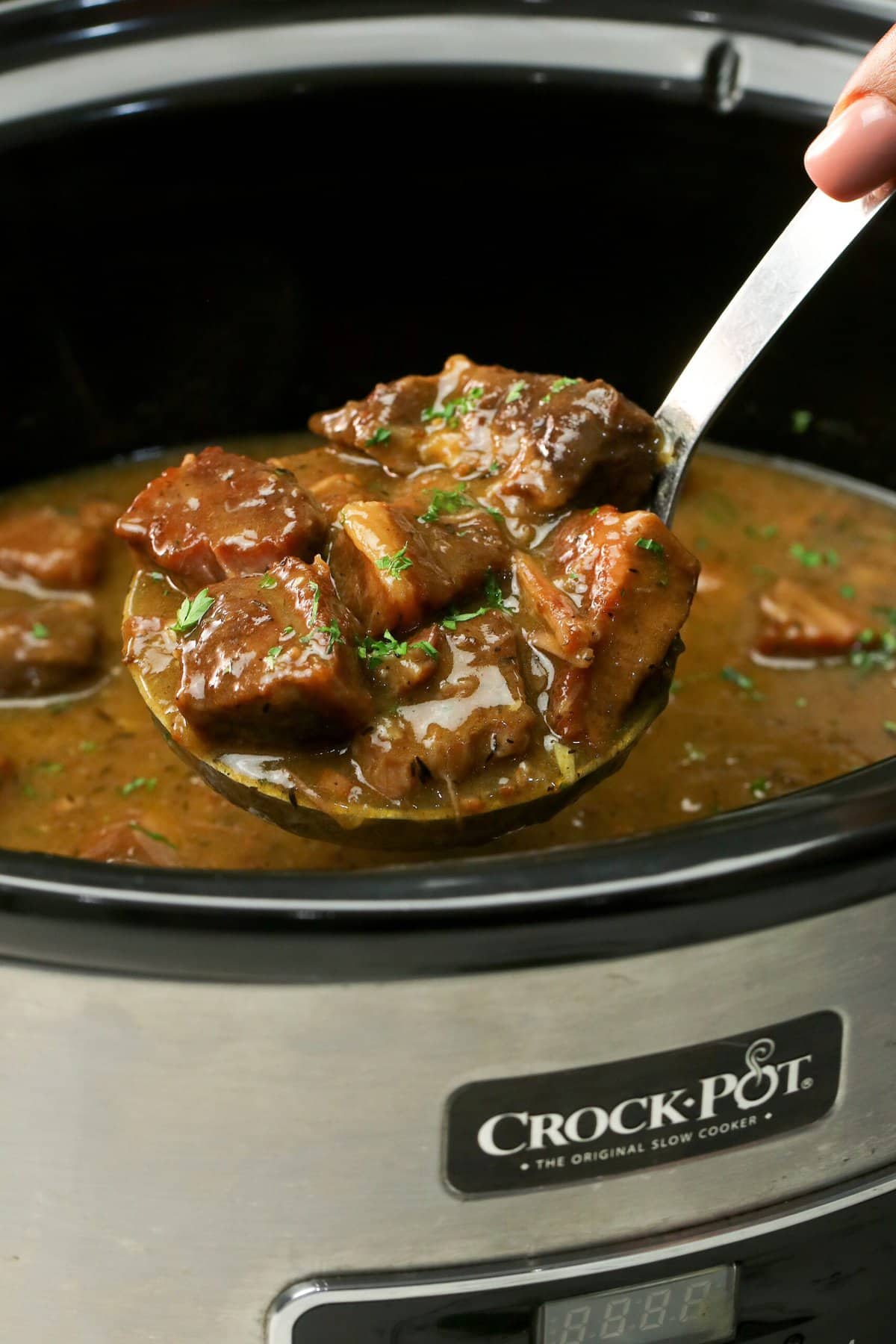 Ladling up a delicious serving of slow cooker beef tips