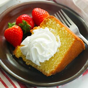 Enjoying a slice of Southern pound cake with fresh strawberries and a dollop of homemade whipped cream