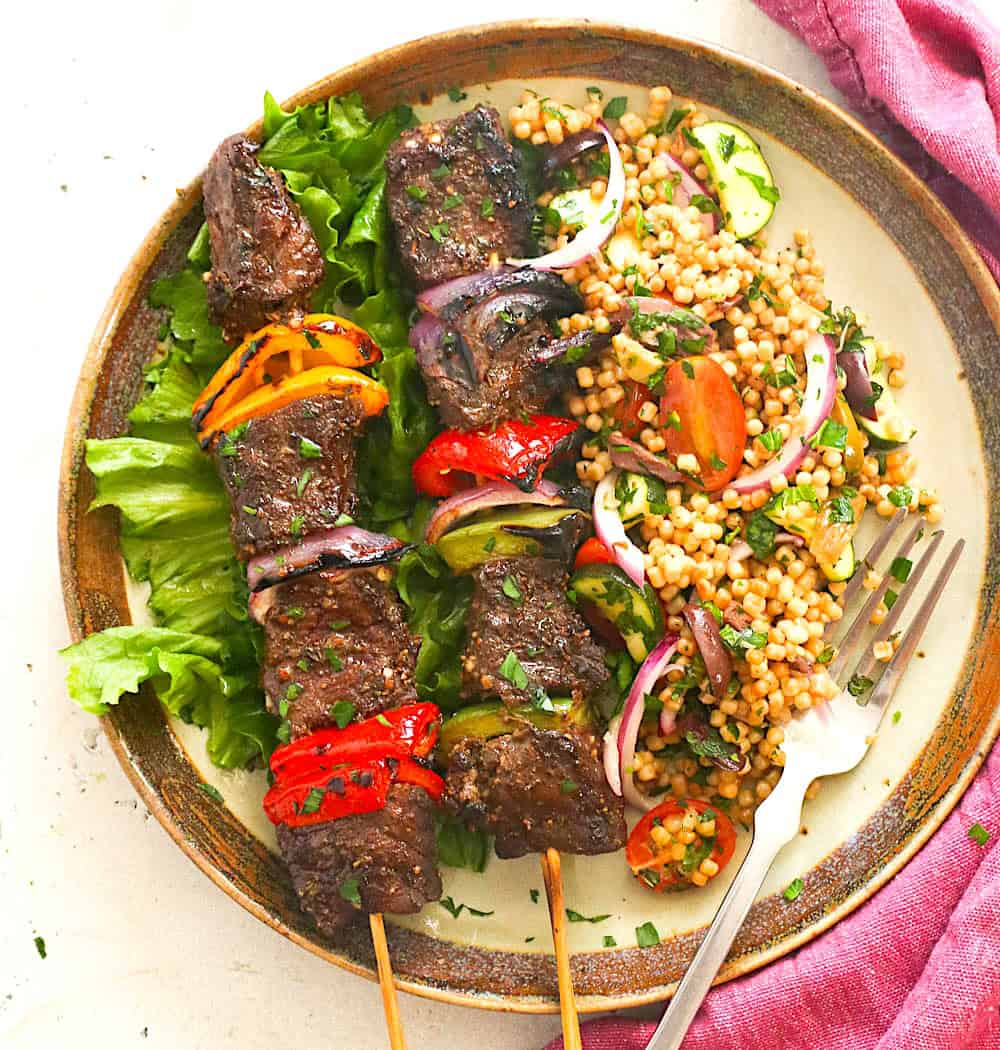 Freshly grilled steak kabob with couscous