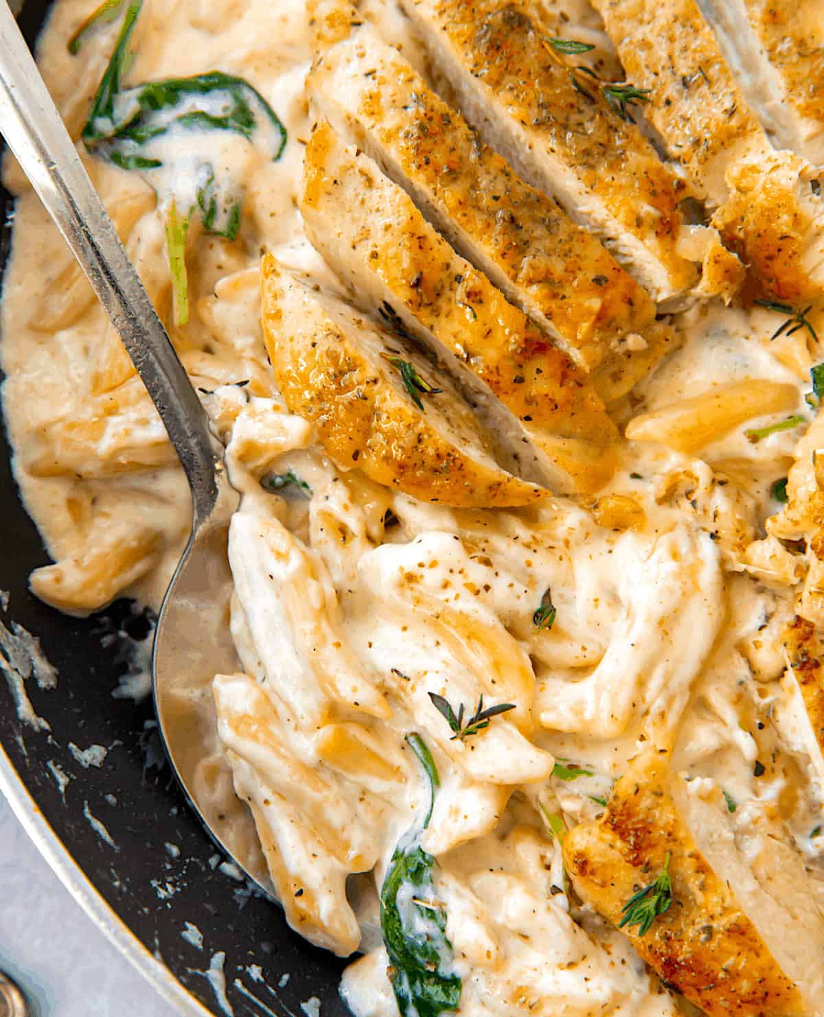 Replenish creamy alphred sauce suffocation pen neo pasta and topped with chicken breasts.