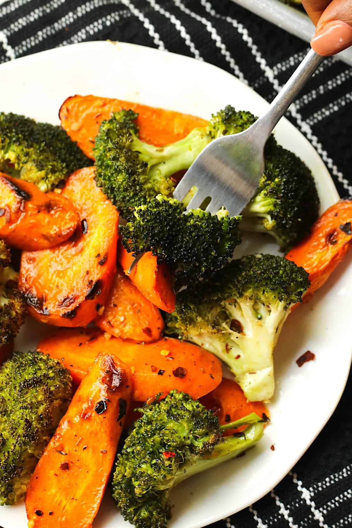 Forking into a deliciously healthy plate of roasted broccoli and carrots