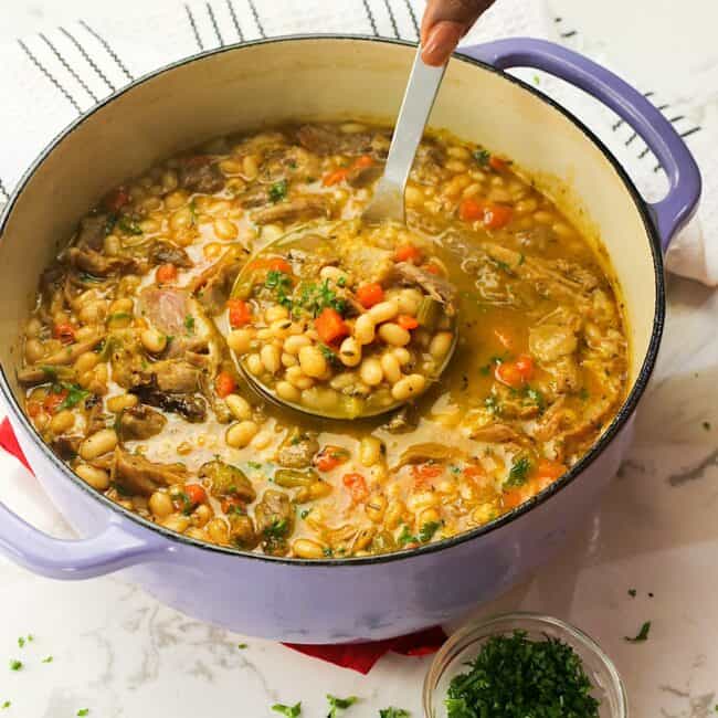 A freshly cooked and steaming hot pot of navy bean soup