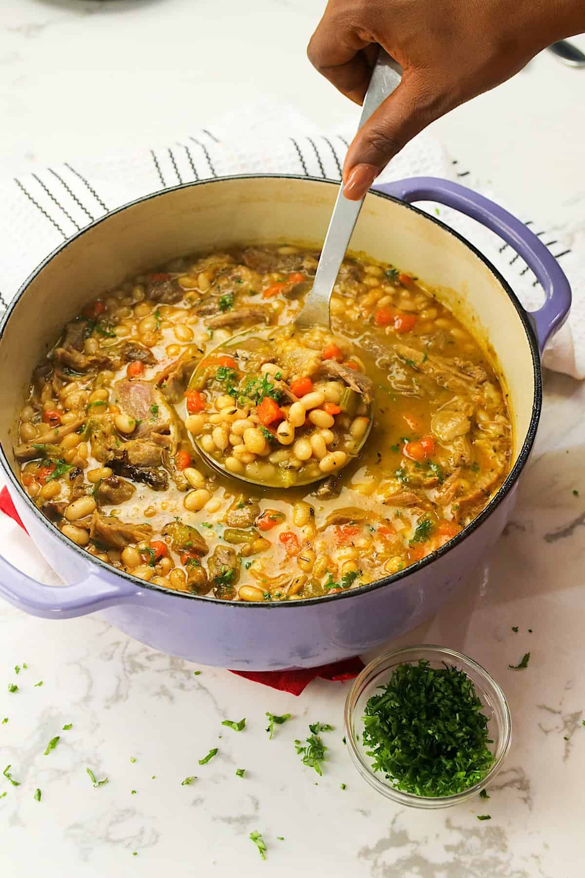 A freshly cooked and steaming hot pot of navy bean soup