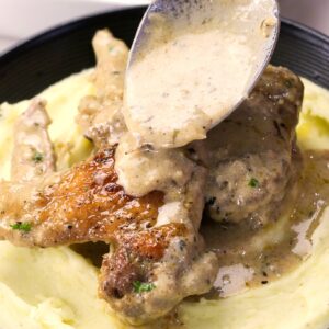 Smothering fall-off-the-bone chicken wings with creamy gravy