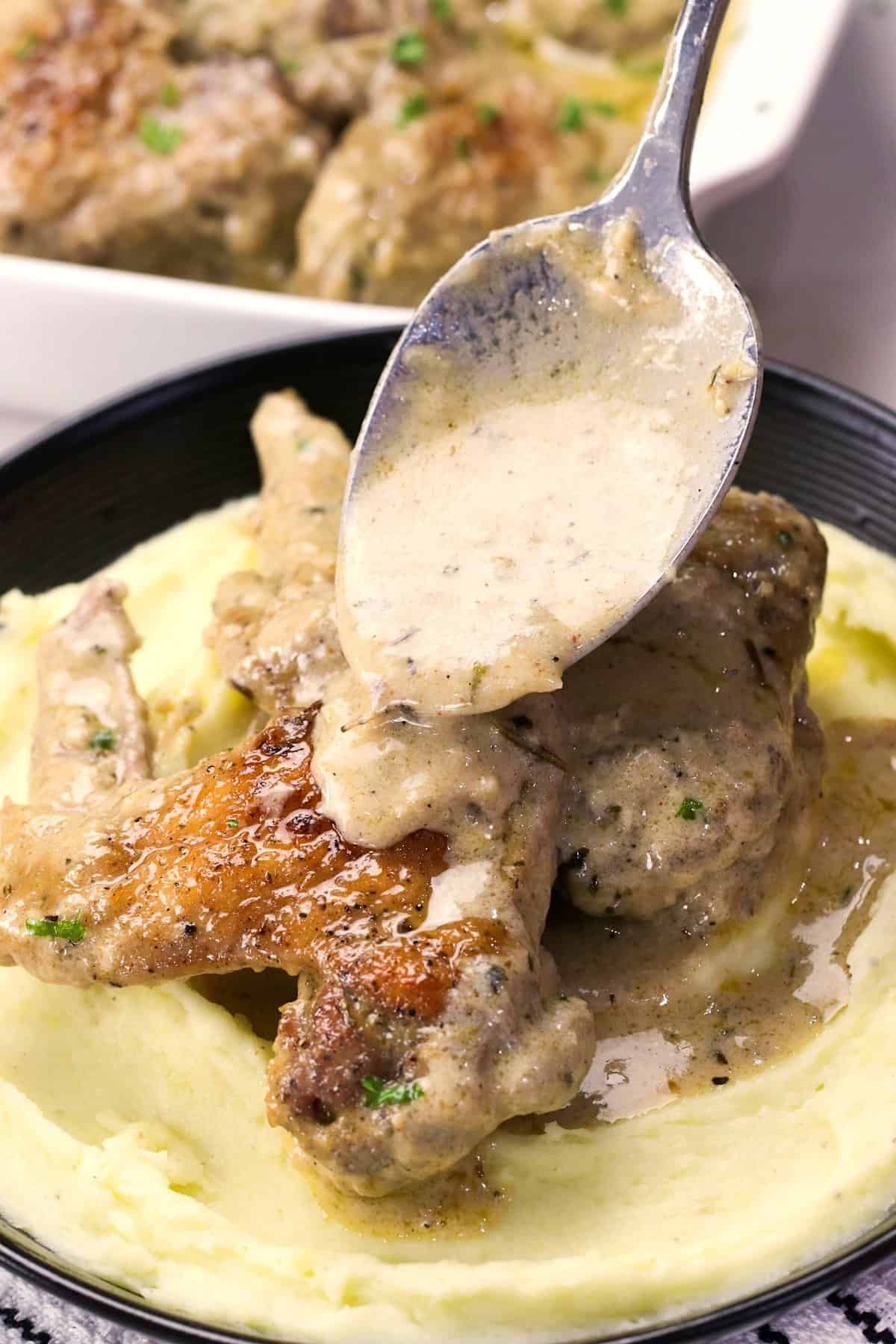 Smothering fall-off-the-bone chicken wings with creamy gravy